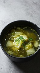 Hearty and delicious cabbage soup, brimming with fresh, green vegetable pieces and fragrant herbs in a rich, steaming liquid ,farm fresh ,culinary ,hot