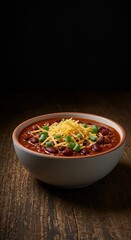 Hearty bowl of rich, slow-cooked chili resting on a rustic wooden table, garnished with shredded cheese and green onions, perfect comfort food ,cooked ,overhead view ,autumn