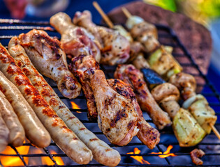 bbq with grilled sausage, chicken, skewers, mushrooms, outdoors, south african traditional braai with boerewors