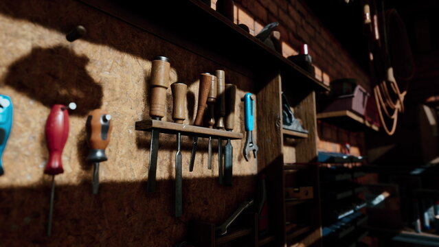 This workshop features an array of handcrafted woodworking tools displayed neatly on a textured wooden wall. Sunlight streams in, casting shadows that enhance the warm atmosphere of creativity.