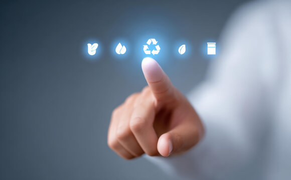 Focused hand and finger touch glowing recycling icon. concept for sustainability, technology, and environment protection, conscious choice for green future