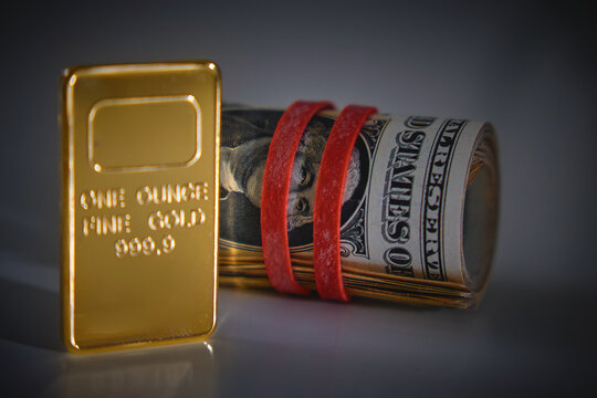 Gold ingot and rolled paper money symbolizing wealth, finance, and investment