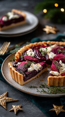 Festive beetroot and goat cheese tart with thyme on a rustic plate. Savory holiday baking for a Christmas dinner appetizer