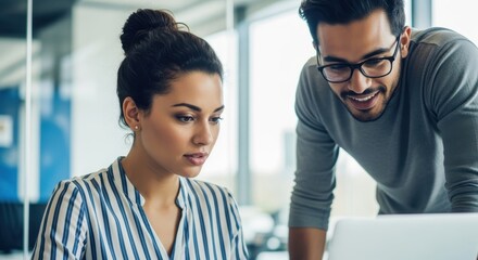 Two colleagues collaborating on a project in a modern office setting