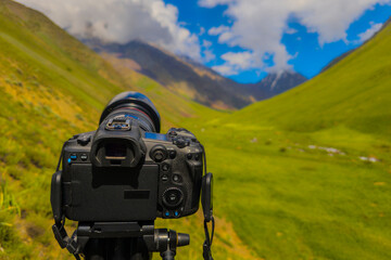 Camera positioned to photograph stunning mountainous landscape during daytime. Natural environment...