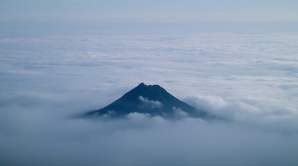 Volcano summit piercing through serene cloud inversion landscape
