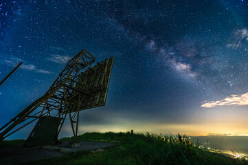 Experience a mysterious sunrise at Waishuangxi, Taiwan, with Keelung Islets, fishing boats, and a dreamy orange golden sky as sun peeks through clouds.