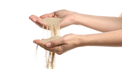 Close-up of two hands holding and letting fine sand flow through fingers