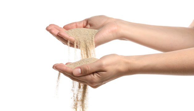 Close-up of two hands holding and letting fine sand flow through fingers