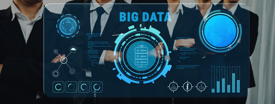 A group of business professionals stand confidently as they analyze big data trends displayed on a digital interface, showcasing analytics metrics in a modern workspace. Trope