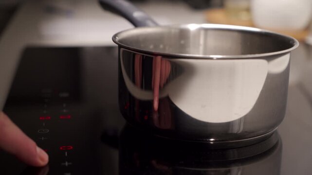 Pot Heats as Finger Beeps Induction Cooktop to Raise Cooking Temperature.