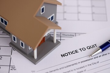 Generic house and eviction notice or notice to quit on table close up
