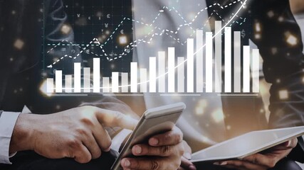 A contemporary business scene showcasing hands holding a smartphone and tablet, with graphs and charts overlay, symbolizing growth and financial analysis in a modern office. Copula - Powered by Adobe