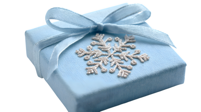 Soft gift in powder blue paper with embroidered snowflake patch and satin ribbon, delicate texture, isolated on white background