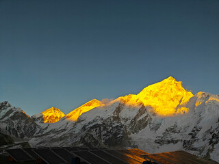 Stunning mountain range bathed in golden light at dawn showcasing natural beauty. Nepal, Himalayas.