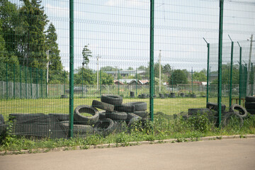 Fence around the sports field. High fence.