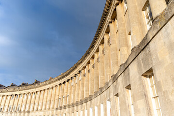 Curved historic architecture under cloudy sky