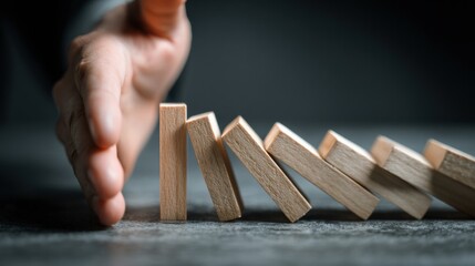 Hand Pushes Domino Upright to Reverse Chain Reaction and Symbolize Control and Recovery in a Calm Setting