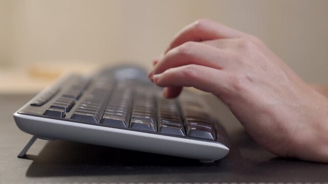 Focused Writer at Work: Fingers Click and Clack Steadily on External Keyboard