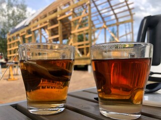 tea break at a construction site, cups of tea in the foreground