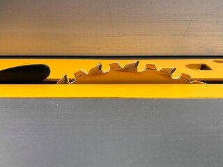sharp teeth of a yellow circular saw close up