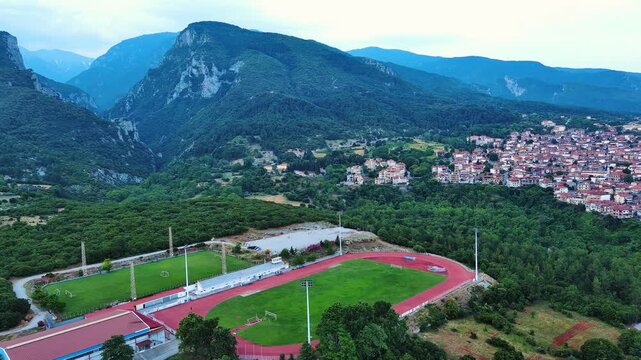 Large sports ground near the Greek town of Litochoro against the backdrop of the Mount Olympus and a cloudy sky