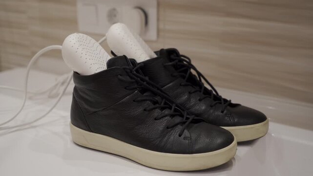 Quiet Care: Electric Shoe Dryers Comfortably Renew Black Leather Shoes