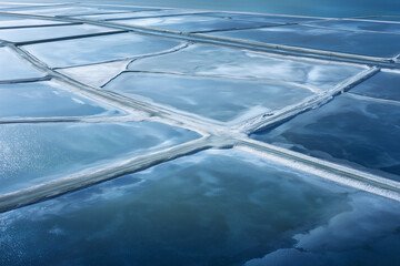 Partially Frozen Salt Evaporation Ponds At Blue Hour, Geometric Crystallization Patterns, Overhead Aerial Near Baltic Coast