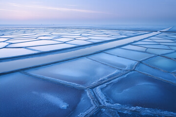Partially Frozen Salt Evaporation Ponds At Blue Hour, Geometric Crystallization Patterns, Overhead Aerial Near Baltic Coast