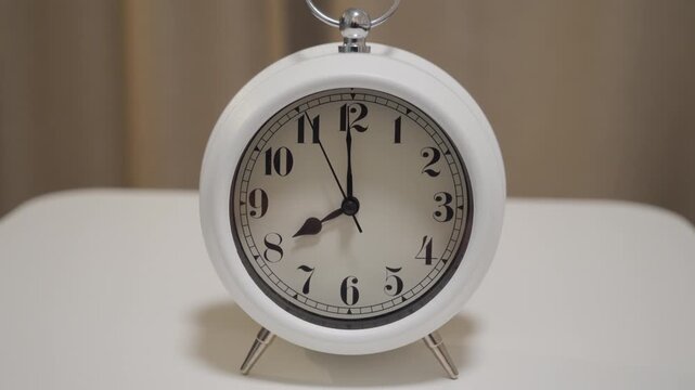 White Alarm Clock Runs, Time is Exactly 8:00.