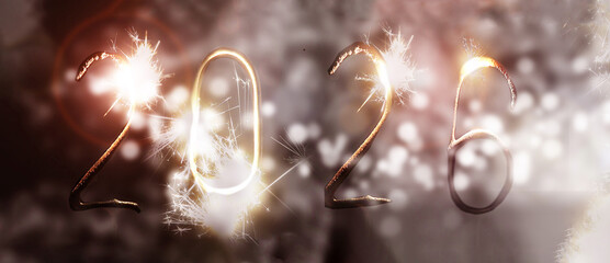 numbers 2026 made from sparklers on bokeh lights. New Year banner.
