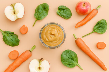 Flat lay of healthy baby food puree and fresh apple, spinach and carrot. Organic homemade baby meal concept.