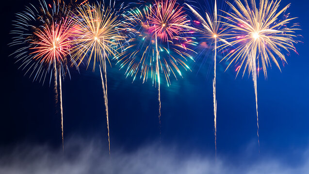 Vibrant and spectacular fireworks illuminate the dark night sky, creating a dazzling display of light and color for celebration and festive events
