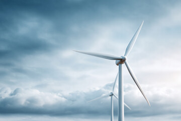 Two wind turbines stand against a dramatic sky, representing clean energy and sustainability. Perfect for illustrating ecofriendly initiatives and green technology.