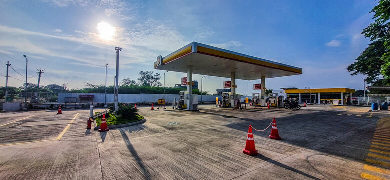 Madurai, Tamilnadu, India - December 28, 2023: A Shell fuel station in Madurai, seen during a bright morning. The forecourt appears clean with fuel pumps, safety cones, and customer refueling vehicles