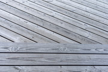 Obraz premium Close-up view of weathered gray wooden deck with natural patterns and textures 