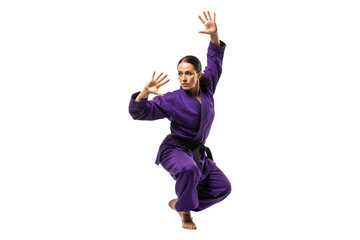 Female martial artist in a purple gi performing a dynamic kata pose