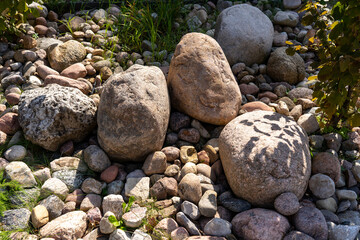 Natural stones in garden landscape, textured surface, ideal for landscaping and decorative elements, copy space
