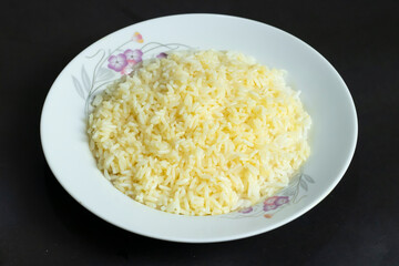 fluffy white rice presented in an elegant floral plate, ideal for culinary projects, healthy eating visuals, and comforting food themes.