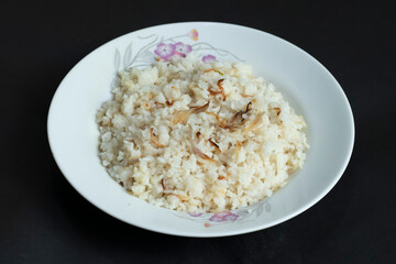 white rice adorned with savory crispy fried onions, perfect for any culinary presentation.