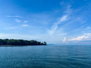 Beautiful tropical island scenery with clear blue sky and calm ocean for travel and vacation ads