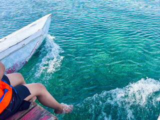 Feel the ocean breeze while boating on clear turquoise water during a sunny summer day adventure