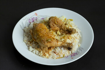 tender chicken drumsticks nestled on a bed of perfectly cooked white rice, ideal for family dinners or casual dining.