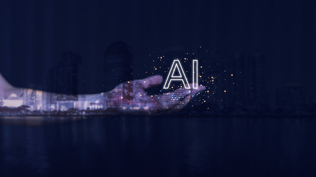 Human hand holding glowing AI text with digital light particles over modern city background, symbolizing artificial intelligence, innovation, data technology, and futuristic smart solutions.