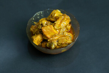 chicken curry, bathed in a rich golden sauce, presented in a clear bowl. Ideal for food blogs, menus, and culinary advertising to spark appetite.