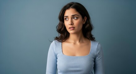 Contemplative Stare: A woman with dark, flowing hair and a look of thoughtful concern gazes off to the side, her expression conveying a sense of introspection and slight unease. 