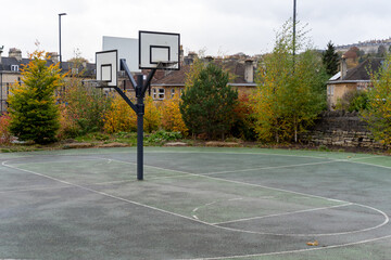 Empty outdoor basketball court in autumn