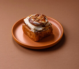 Cinnabon, a sweet cinnamon pastry, a high calorie bun or roll. Cinnabon with cinnamon