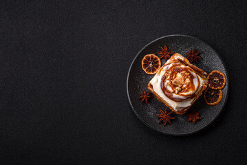 Cinnabon, a sweet cinnamon pastry, a high calorie bun or roll. Cinnabon with cinnamon