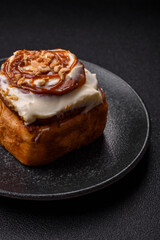 Cinnabon, a sweet cinnamon pastry, a high calorie bun or roll. Cinnabon with cinnamon